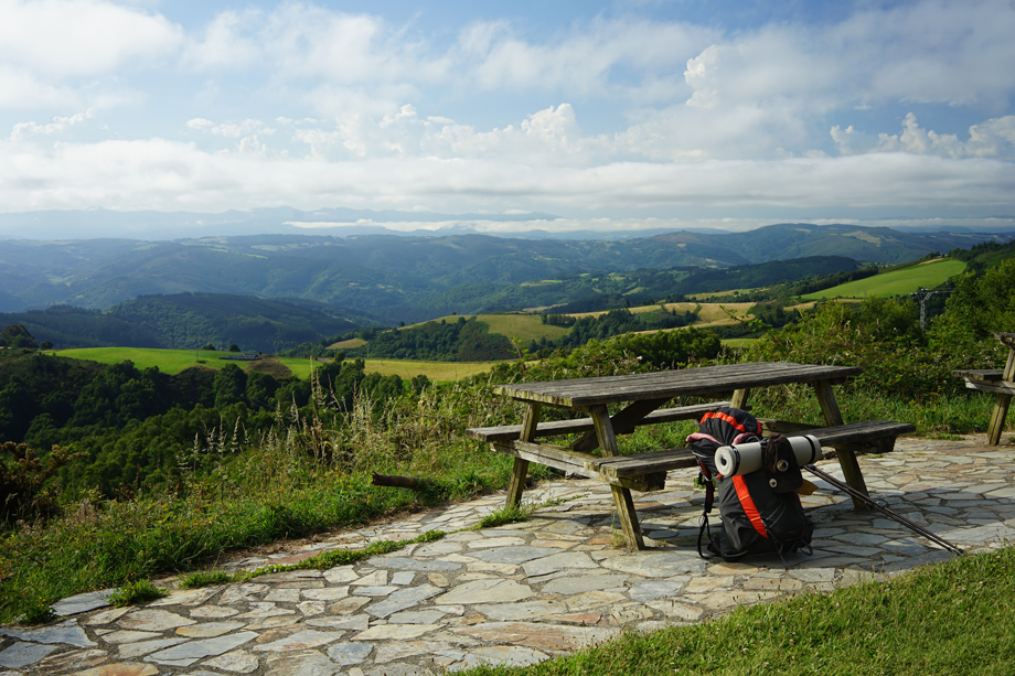 Backpack resting against a bench on the Camino Primitivo